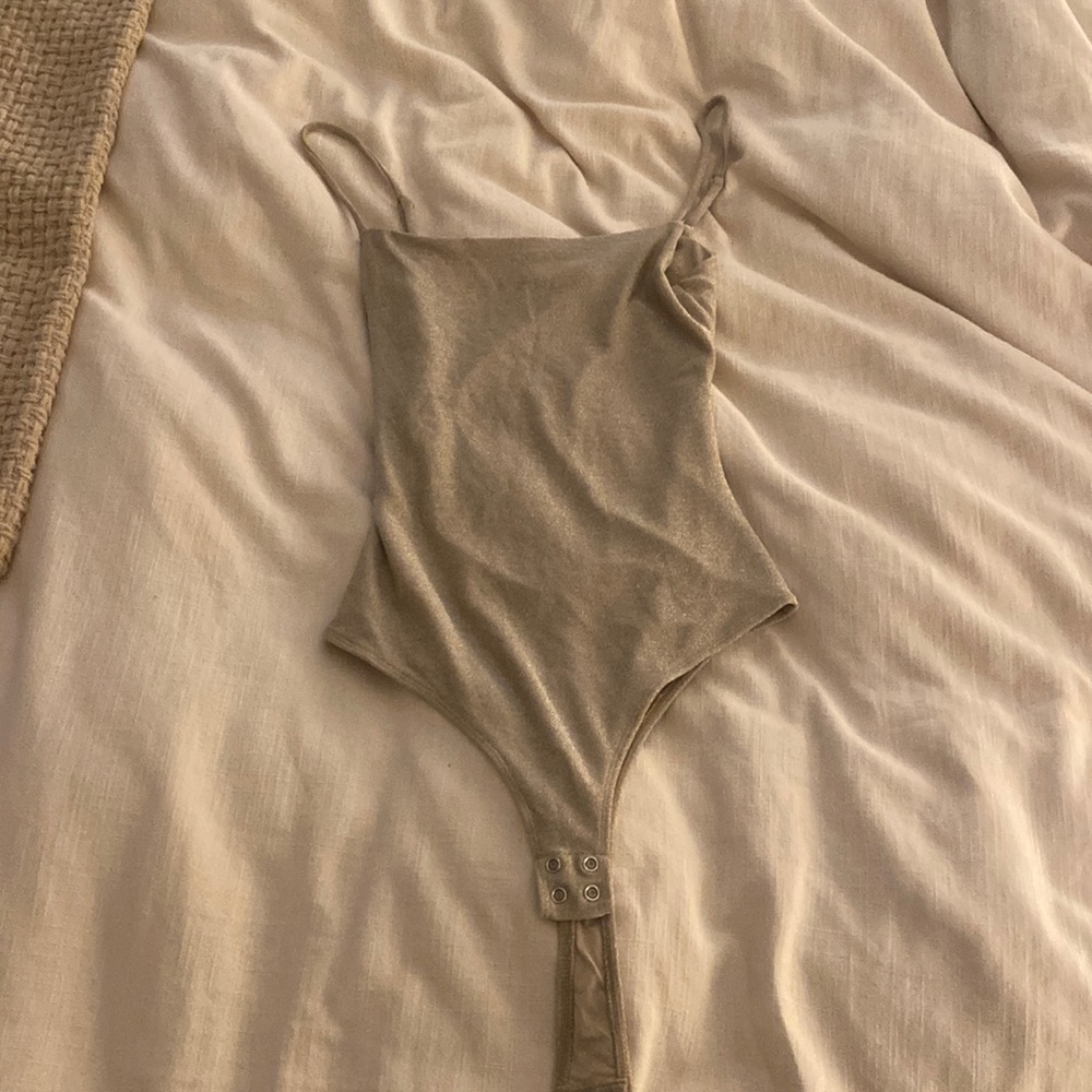 Dynamite bodysuit with snaps, cutout back with a crossover at the top